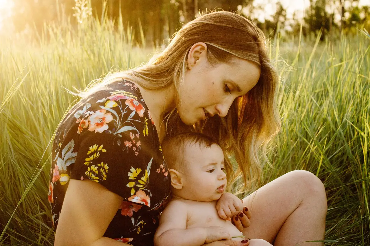 Mother and her baby in a field.